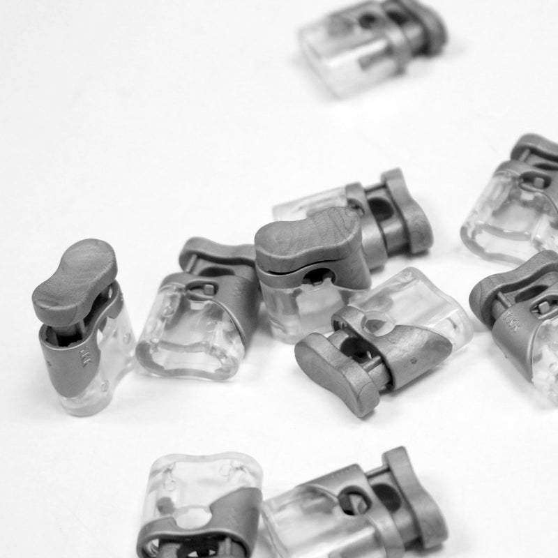 Bloque cordon YKK - Stop cordon gris clair & transparent, 1 trou, YKK - TissusPapi.com