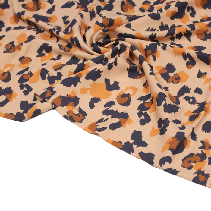 Tissu viscose fluide aux motifs léopard gris et oranges, fond orange clair - OEKO-TEX®