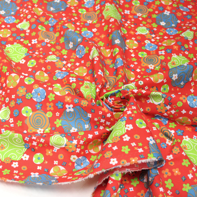 Tissu cotonnade SEVENTIES rouge et formes psychédéliques oranges, bleues, vertes