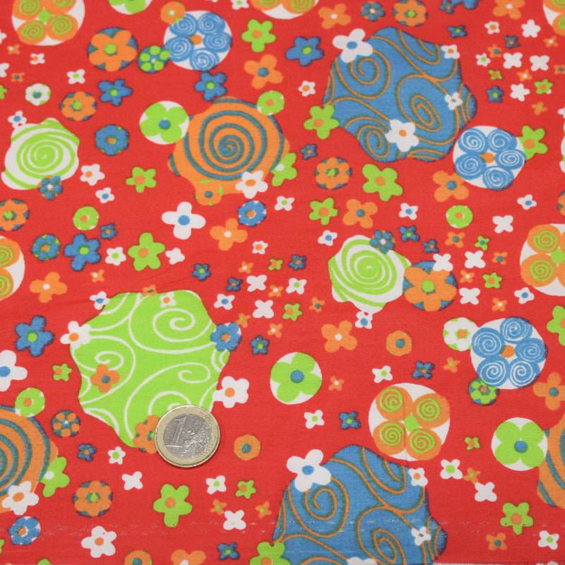 Tissu cotonnade SEVENTIES rouge et formes psychédéliques oranges, bleues, vertes