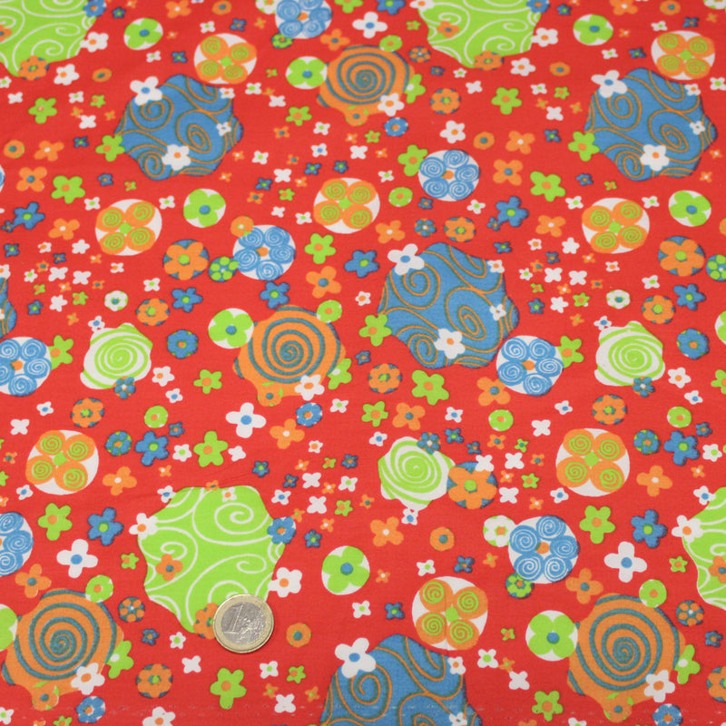 Tissu cotonnade SEVENTIES rouge et formes psychédéliques oranges, bleues, vertes