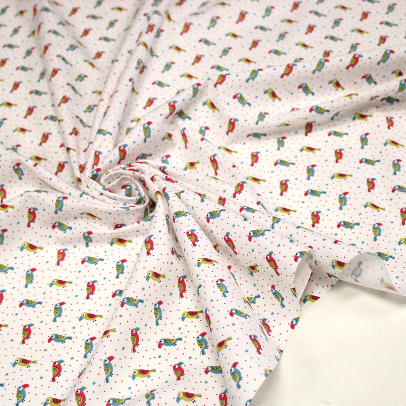 Tissu cotonnade enfant aux petits toucans multicolores sur fond blanc