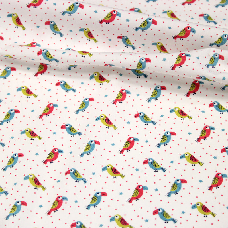 Tissu cotonnade enfant aux petits toucans multicolores sur fond blanc