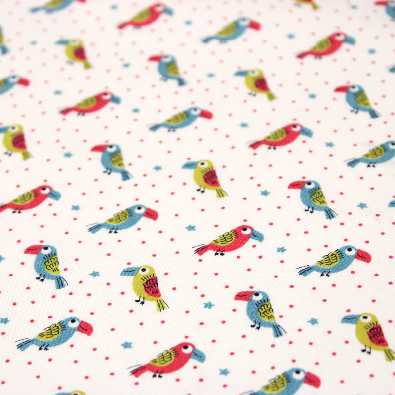 Tissu cotonnade enfant aux petits toucans multicolores sur fond blanc