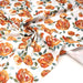 Tissu gabardine coton imprimée blanc aux roses oranges façon aquarelle - TissusPapi.com