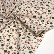 Tissu cotonnade LEOPARD, écru et taches léopard noires, roses, ocres - OEKO - TEX STANDARD 100 - TissusPapi.com