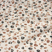 Tissu cotonnade LEOPARD, écru et taches léopard noires, roses, ocres - OEKO - TEX STANDARD 100 - TissusPapi.com
