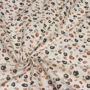 Tissu cotonnade LEOPARD, écru et taches léopard noires, roses, ocres - OEKO - TEX STANDARD 100 - TissusPapi.com