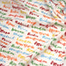 Tissu popeline coton blanc aux noms de ville multicolores, collection VOYAGE - TissusPapi.com