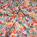 Tissu popeline coton, les autocollants de voyages, tons orange et bleus - TissusPapi.com