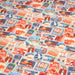 Tissu popeline coton, les autocollants de voyages, tons orange et bleus - TissusPapi.com