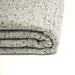 Tissu Tweed coton laine faux-uni blanc gris, taches noires - Fabrication française - TissusPapi.com
