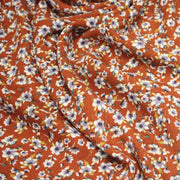 Tissu Viscose crêpe rouille, fleuri blanc & mauve et liserés lurex dorés - TissusPapi.com