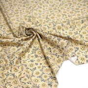 Tissu popeline coton ocre clair aux fleurs & fines arabesques noirs et jaunes - TissusPapi.com