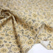 Tissu popeline coton ocre clair aux fleurs & fines arabesques noirs et jaunes - TissusPapi.com