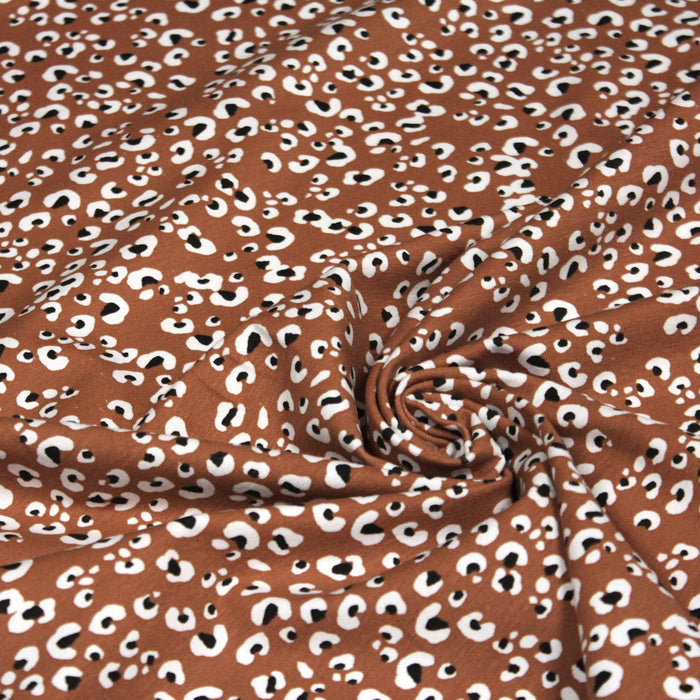 Tissu jersey de coton motif Léopard noir & blanc, fond marron rouille - OEKO-TEX