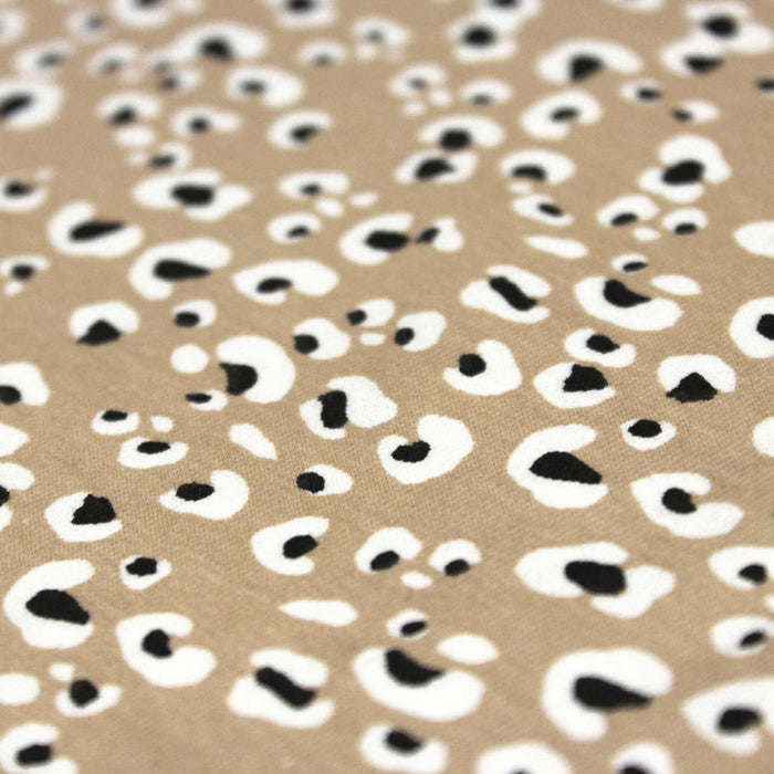 Tissu jersey de coton motif Léopard noir & blanc, fond naturel sable - OEKO-TEX