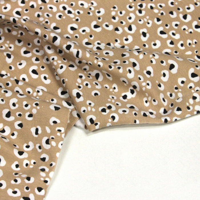 Tissu jersey de coton motif Léopard noir & blanc, fond naturel sable - OEKO-TEX