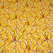 Tissu popeline de coton SUMATRA au feuillage tropical jaune, fond blanc
