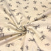 Tissu de coton de Noël scandinave aux rennes taupe, fond écru