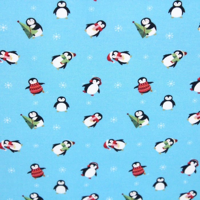 Tissu popeline de coton de Noël aux pingouins de Noël, fond bleu ciel - Oeko-Tex