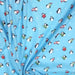 Tissu popeline de coton de Noël aux pingouins de Noël, fond bleu ciel - Oeko-Tex