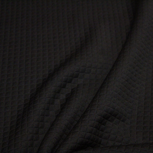 Tissu Jersey noir matelassé aux petits losanges