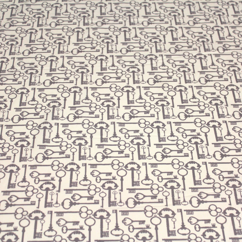 Tissu popeline de coton aux clefs vintage taupe, fond écru - TissusPapi.com