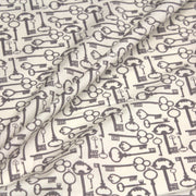 Tissu popeline de coton aux clefs vintage taupe, fond écru - TissusPapi.com