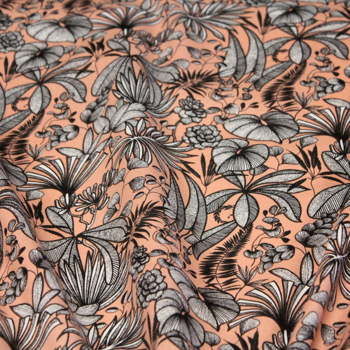 Tissu de coton JAVA aux fleurs & feuilles noires et blanches, fond corail - Oeko-Tex