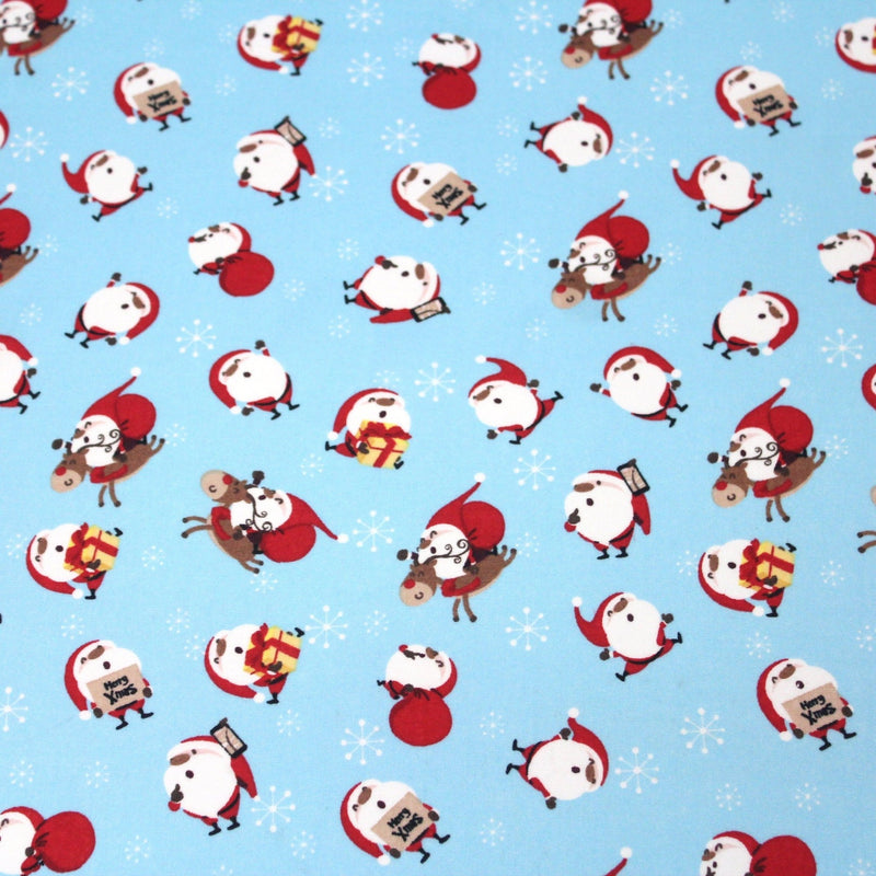 Tissu popeline de coton de Noël - Le père Noël, fond bleu ciel - TissusPapi.com