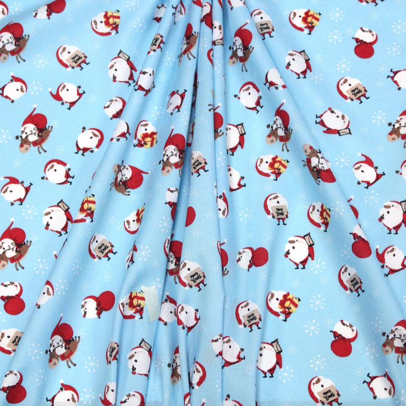 Tissu popeline de coton de Noël - Le père Noël, fond bleu ciel - TissusPapi.com