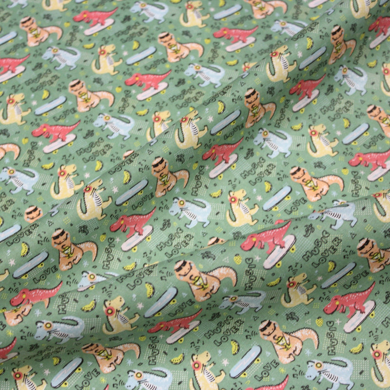 Tissu de coton Dinosaure music lover, fond vert sauge - Oeko - Tex - TissusPapi.com