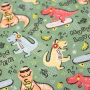 Tissu de coton Dinosaure music lover, fond vert sauge - Oeko - Tex - TissusPapi.com