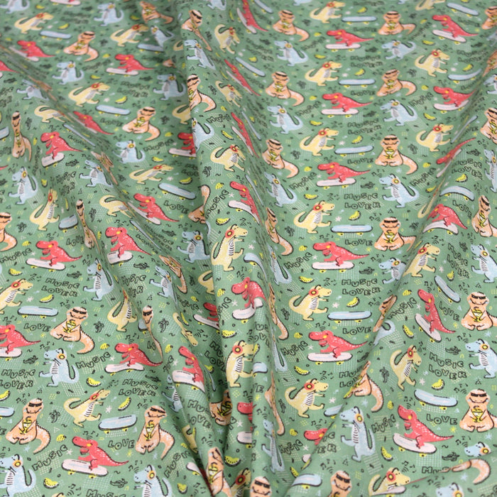 Tissu de coton Dinosaure music lover, fond vert sauge - Oeko-Tex - tissuspapi