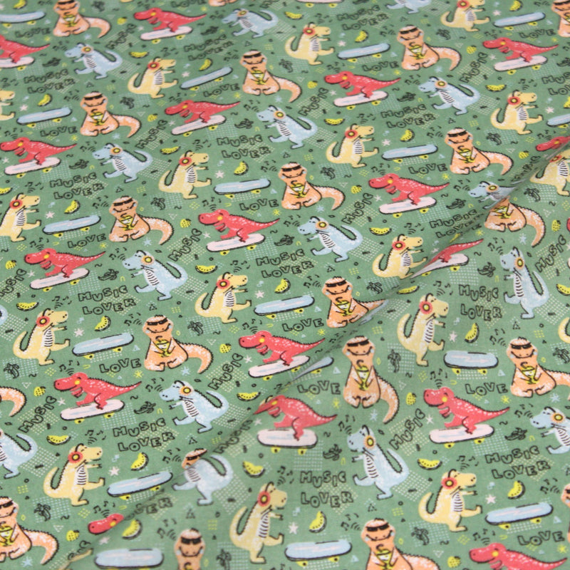 Tissu de coton Dinosaure music lover, fond vert sauge - Oeko - Tex - TissusPapi.com