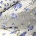 Tissu froissé polyester écru aux fleurs bleues - tissuspapi