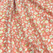 Tissu popeline de coton orange aux petites fleurs blanches et vertes - tissuspapi